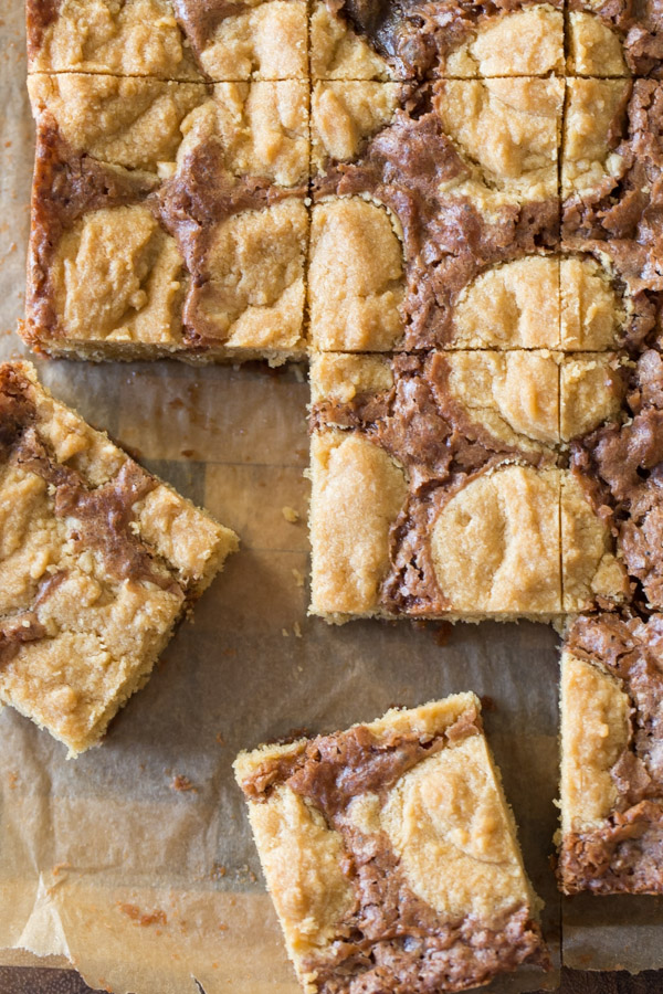 Peanut Butter Cookie Brownies being cut into squares. 