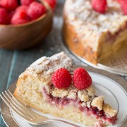 Raspberry Almond Coffee Cake - Layers of moist almond cake, sweetened cream cheese, raspberry preserves and an almond streusel topping.