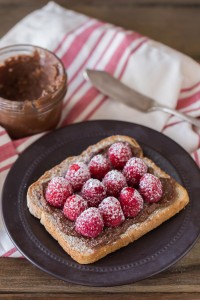 Chocolate Hazelnut Raspberry Toast - Homemade chocolate hazelnut spread on toast with fresh raspberries and powdered sugar.