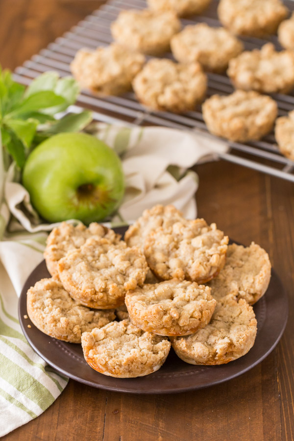 Dutch Apple Pie Cookies arranged on a small plate, with more cookies on a cooling rack in the background.  