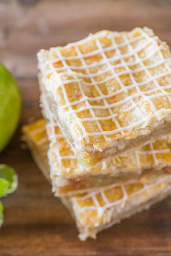 Three Iced Apple Pie Bars stacked on top of each other.  