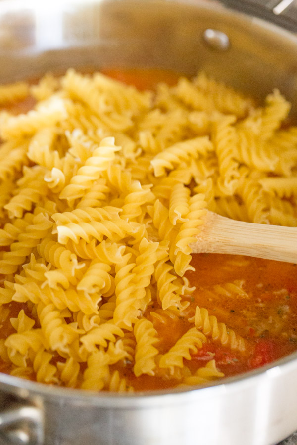 A large pan with all the ingredients for the One Pot Fusilli With Tomato, Basil, and Mozzarella in it.  