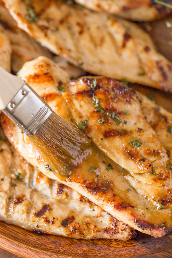 Honey Mustard Sauce being brushed onto the Grilled Chicken.