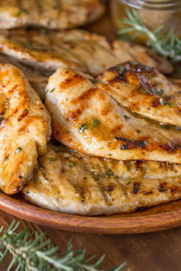 Honey Mustard Grilled Chicken breasts on a wood plate. 