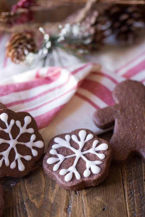Snowflake Chocolate Cut-Out Cookies that have been decorated with icing, and a Gingerbread Man Chocolate Cut-Out Cookie.