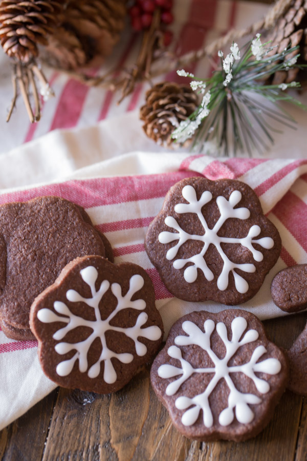 Snowflake Chocolate Cut-Out Cookies that have been decorated with icing. 
