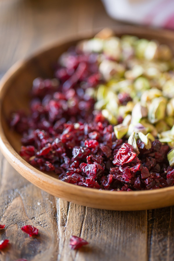 Chopped Cranberries and Pistachios in a wood bowl.  