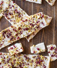 Cranberry Pistachio Butter Cracker Bark - A thin layer of white chocolate on a flaky buttery cracker with a sprinkle of dried cranberries and pistachios.