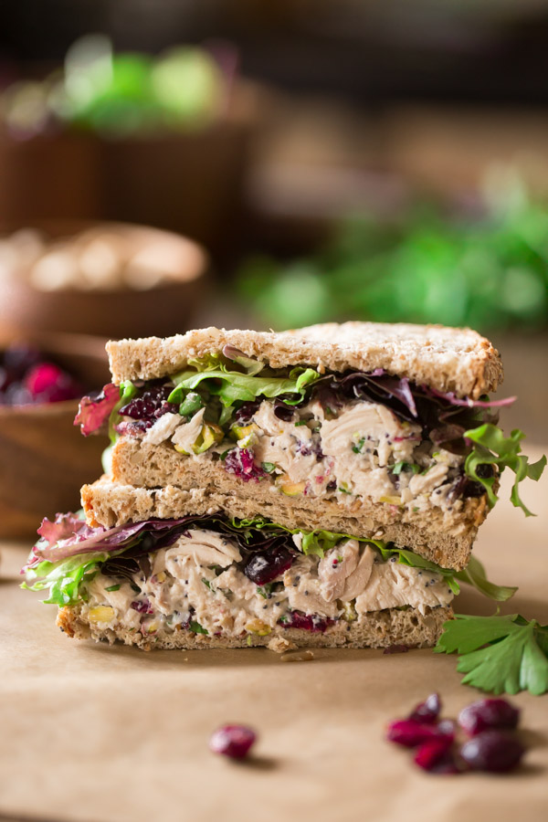 A Cranberry Pistachio Chicken Salad Sandwich cut in half and stacked on top of each other. 