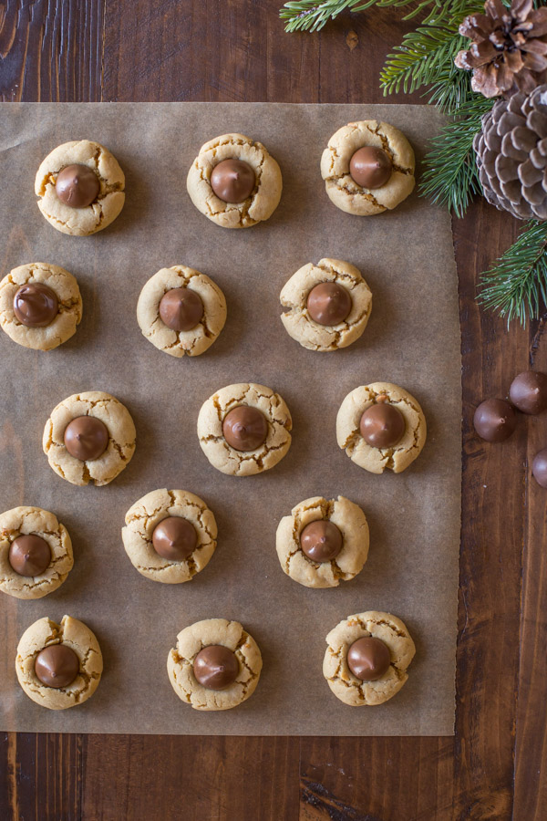 No Shortening Peanut Butter Blossoms sitting on a piece of parchment paper.