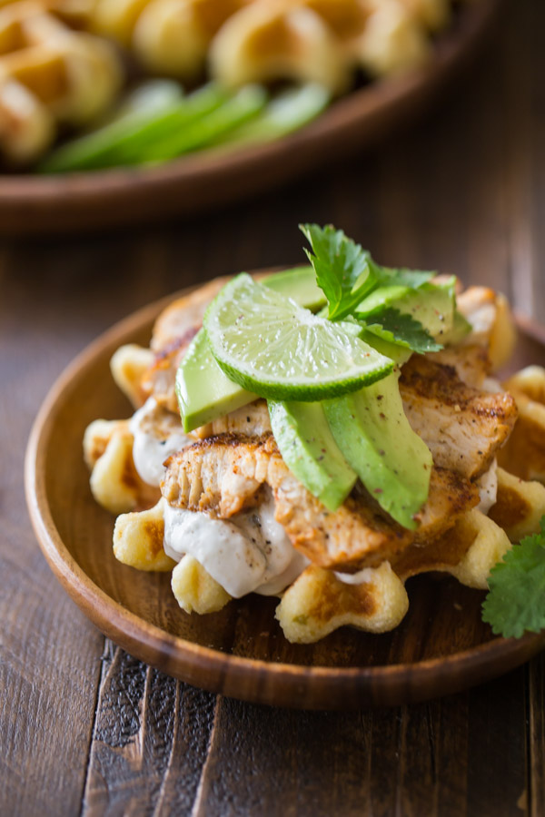 A Green Chile Chicken Waffletada assembled on a small wood plate.  