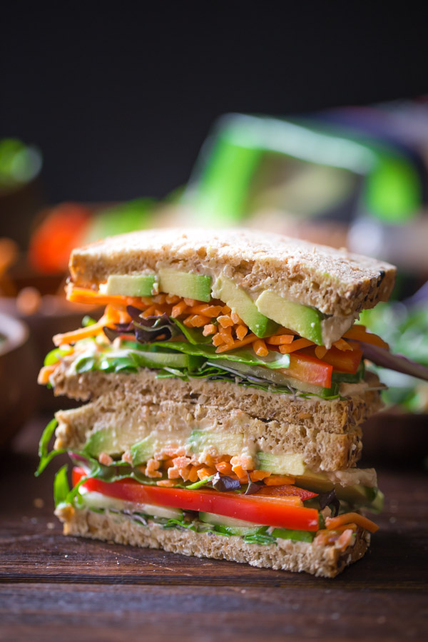 A Power Veggie Sandwich sliced in half and stacked on top of each other.  