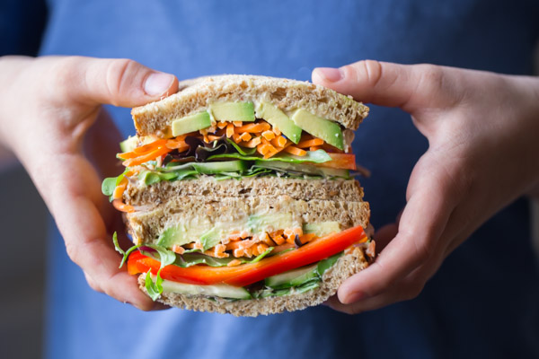 Power Veggie Sandwich sliced in half and stacked on top of each other.  