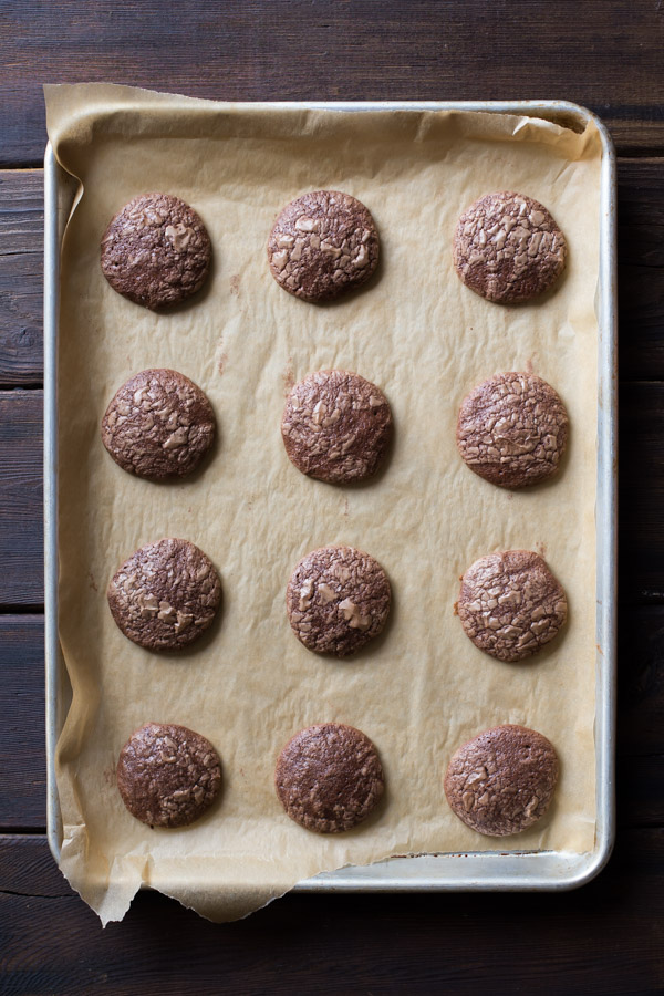 Soft and Chewy Brownie Cookies on a parchment paper lined baking sheet.
