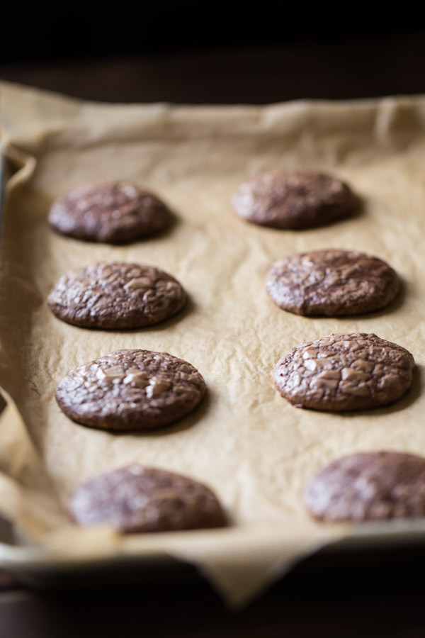 Soft and Chewy Brownie Cookies on a parchment paper lined baking sheet.