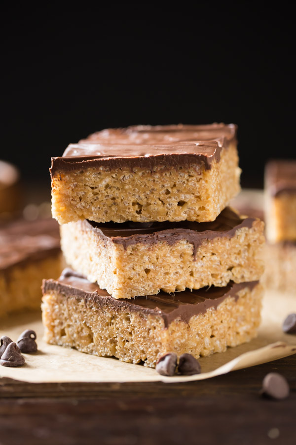 Three Chocolate Peanut Butter Rice Krispie Bars stacked on top of each other.  