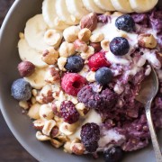Triple Berry Oatmeal Breakfast Bowl - Oats are cooked with frozen berries and then swirled with vanilla yogurt and a sprinkle of crushed hazelnuts. Such a good way to start the day!