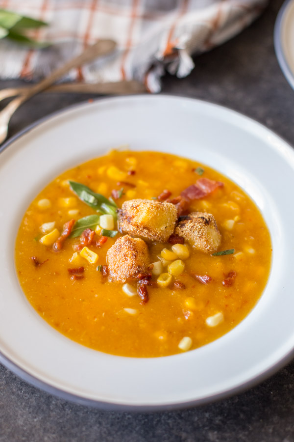 A bowl of Butternut Squash Corn Chowder with Goat Cheese Croutons on top. 