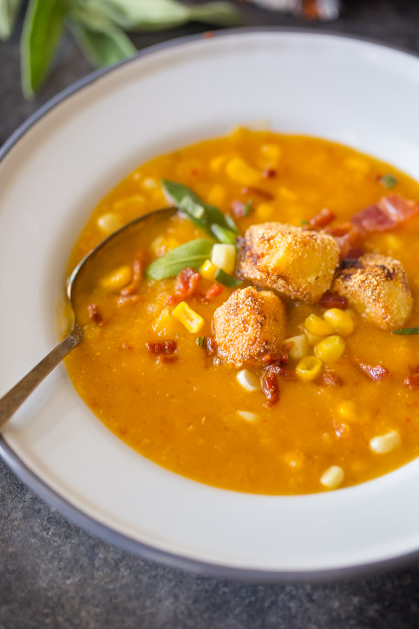 A bowl of Butternut Squash Corn Chowder with Goat Cheese Croutons on top. 