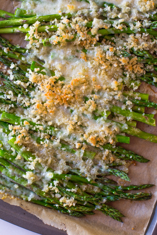 Roasted Asparagus With Panko and Gruyere on a parchment paper lined baking sheet.