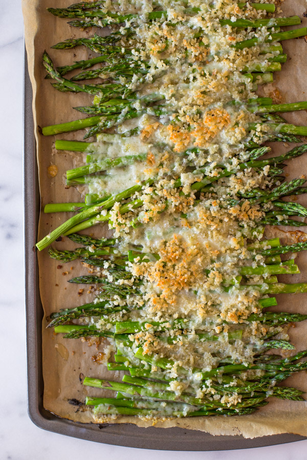 Roasted Asparagus With Panko and Gruyere on a parchment paper lined baking sheet.