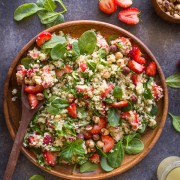Strawberry Couscous Spinach Salad - A bright and cheery spring time salad with strawberries, couscous, spinach, feta, hazelnuts and an almond vinaigrette.