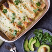 Hatch Green Chile Chicken Enchiladas - Chicken enchiladas with corn and black beans, covered in a creamy Hatch green chile cheese sauce. A quick and easy dinner with just the right amount of heat!