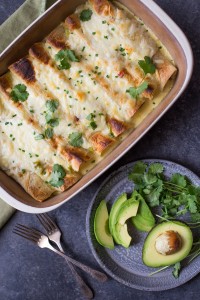 Hatch Green Chile Chicken Enchiladas - Chicken enchiladas with corn and black beans, covered in a creamy Hatch green chile cheese sauce. A quick and easy dinner with just the right amount of heat!