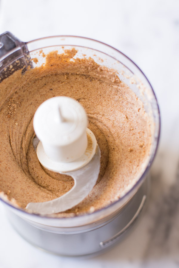 A food processor showing the creamy Homemade Almond Butter.  