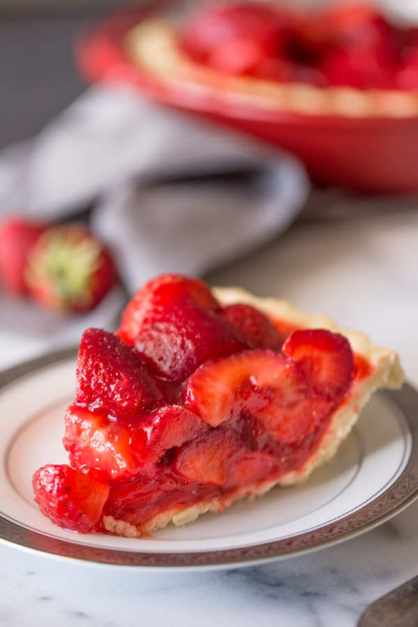 A slice of Fresh Strawberry Pie on a plate.  