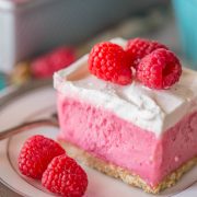 A gorgeous raspberry sherbet dessert with a pretzel crust and a homemade whipped topping! Perfect for summertime get togethers!