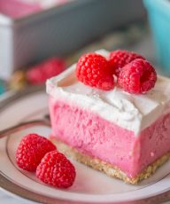 A gorgeous raspberry sherbet dessert with a pretzel crust and a homemade whipped topping! Perfect for summertime get togethers!