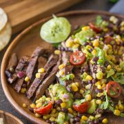 Grilled, marinated flank steak sliced thinly, wrapped in a warm corn tortilla and topped with a fresh mixture of avocado, tomato, corn, and black beans!