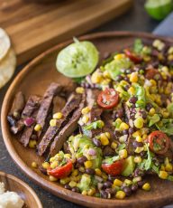 Grilled, marinated flank steak sliced thinly, wrapped in a warm corn tortilla and topped with a fresh mixture of avocado, tomato, corn, and black beans!