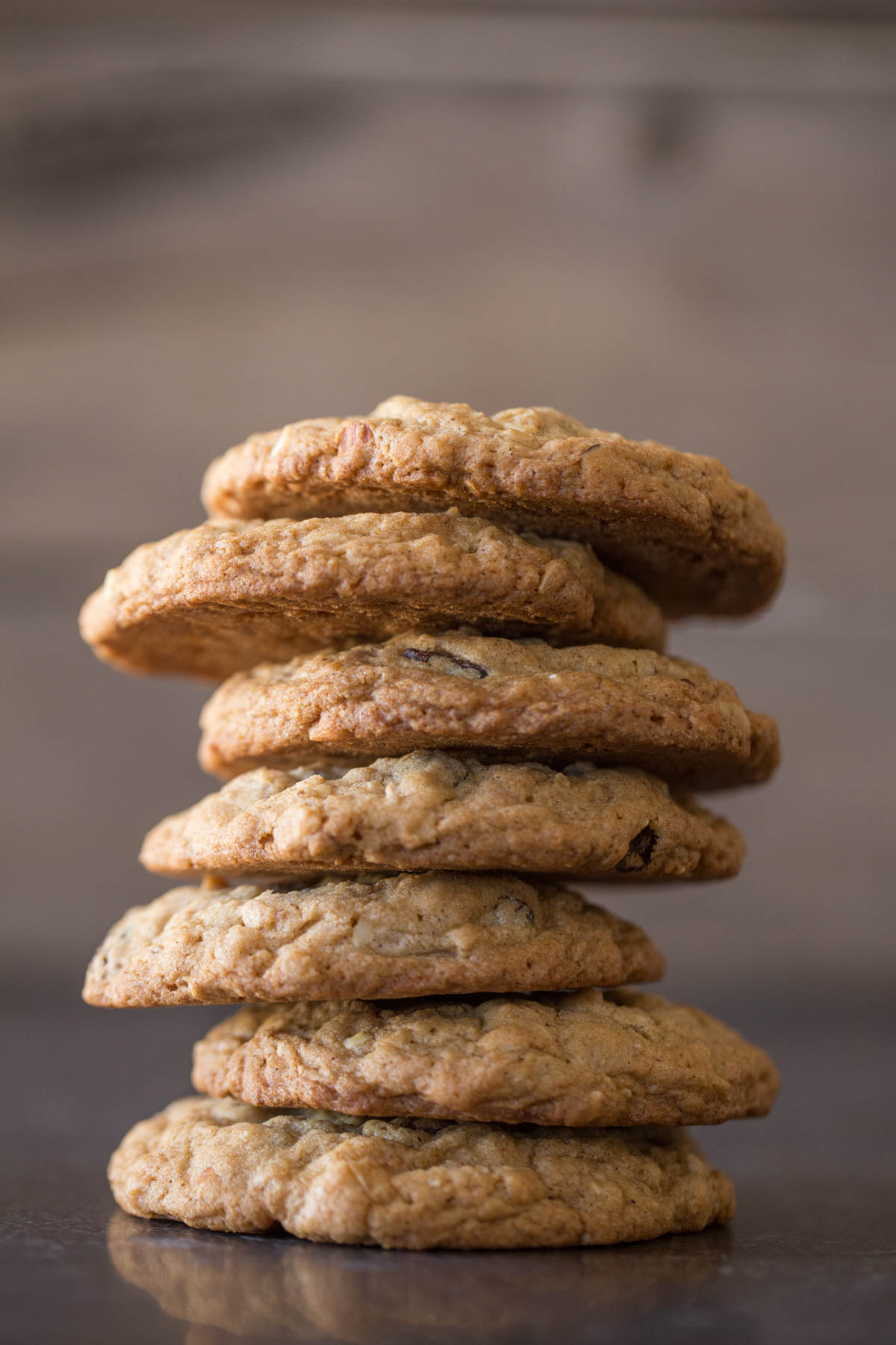 Seven Bakery Style Oatmeal Raisin Cookies stacked on top of each other. 