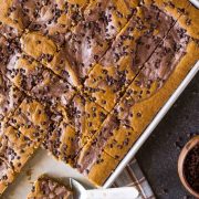 With plenty to feed a crowd, this pumpkin sheet cake with a chocolate cheesecake swirl is perfect for holiday gatherings!