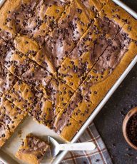 With plenty to feed a crowd, this pumpkin sheet cake with a chocolate cheesecake swirl is perfect for holiday gatherings!