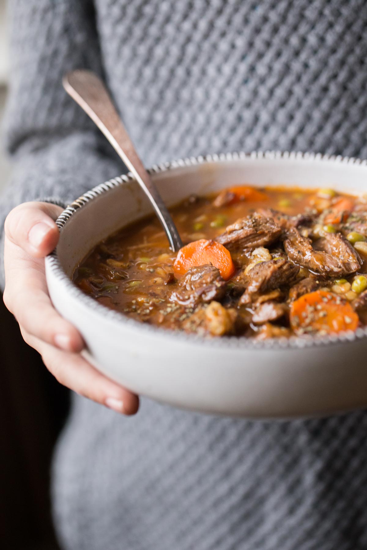 Beef and Barley Vegetable Soup in a bowl with a spoon. 