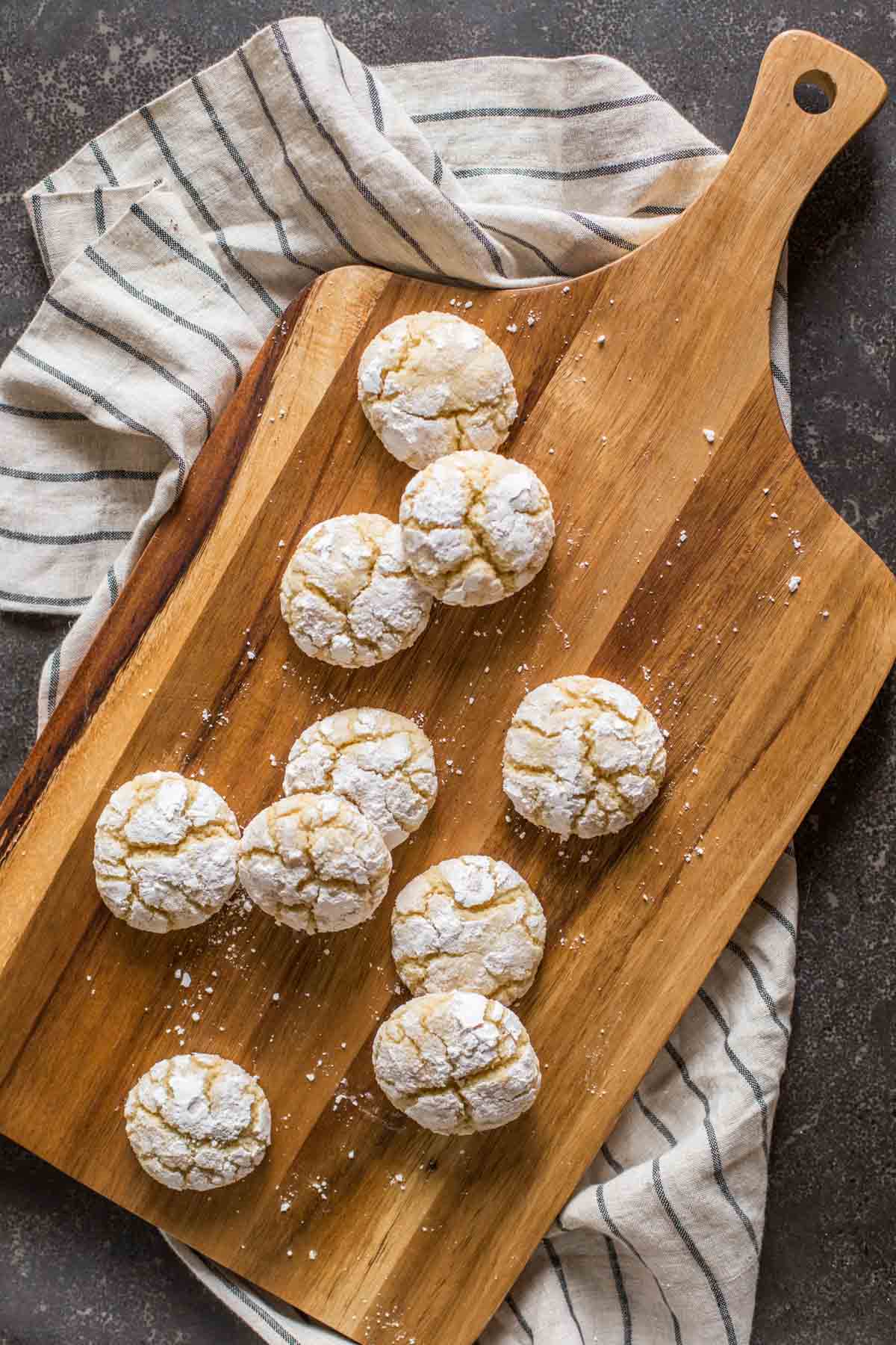 Brown Butter Almond Crinkle Cookies on a wood cutting board.  