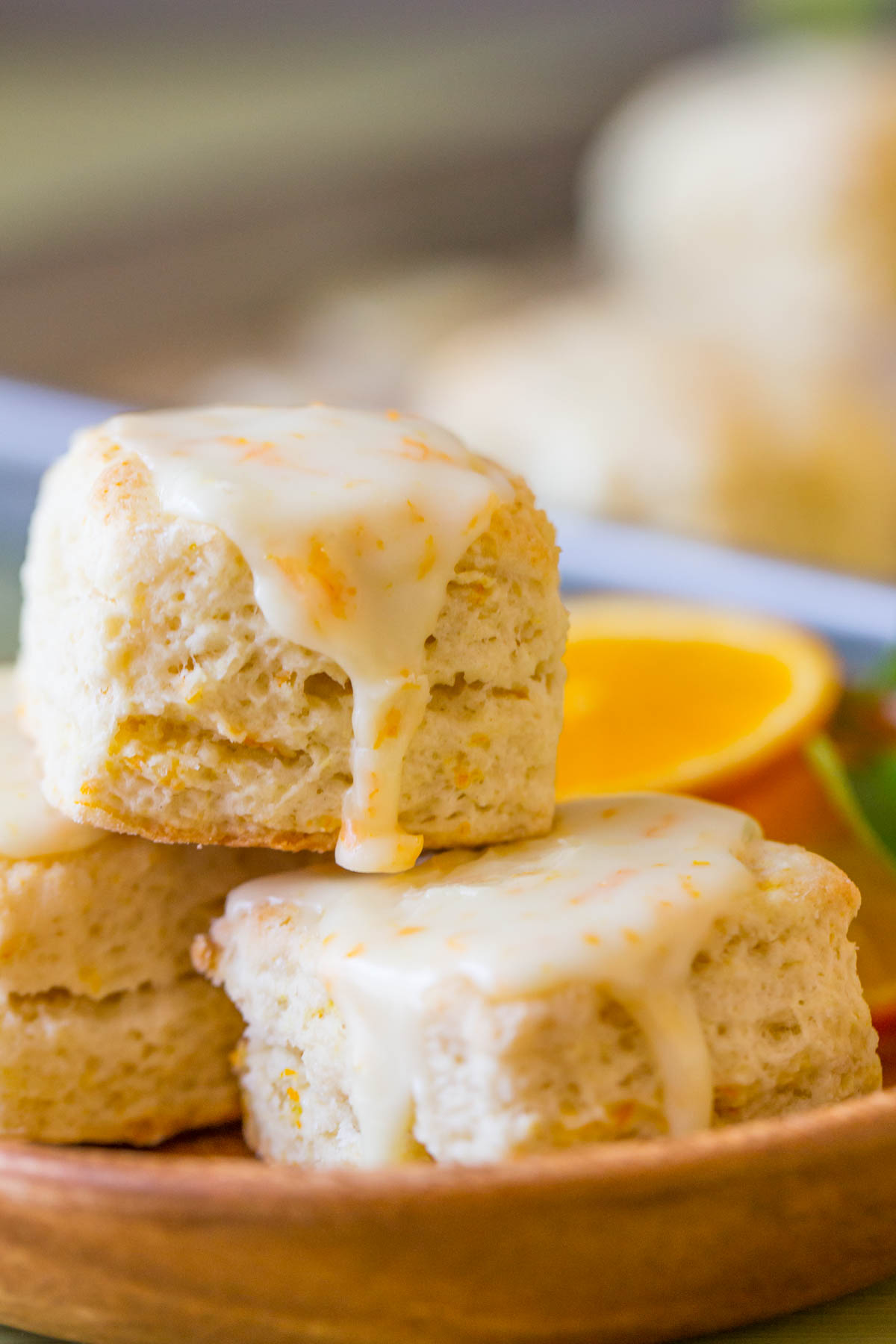 Mini Orange Cream Scones staked on a small wood plate. 