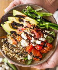 These BLT Bliss Bowls have so much going on! They've got mixed baby greens, oven roasted tomatoes, crisp bacon, avocado, nutty quinoa, and creamy feta.