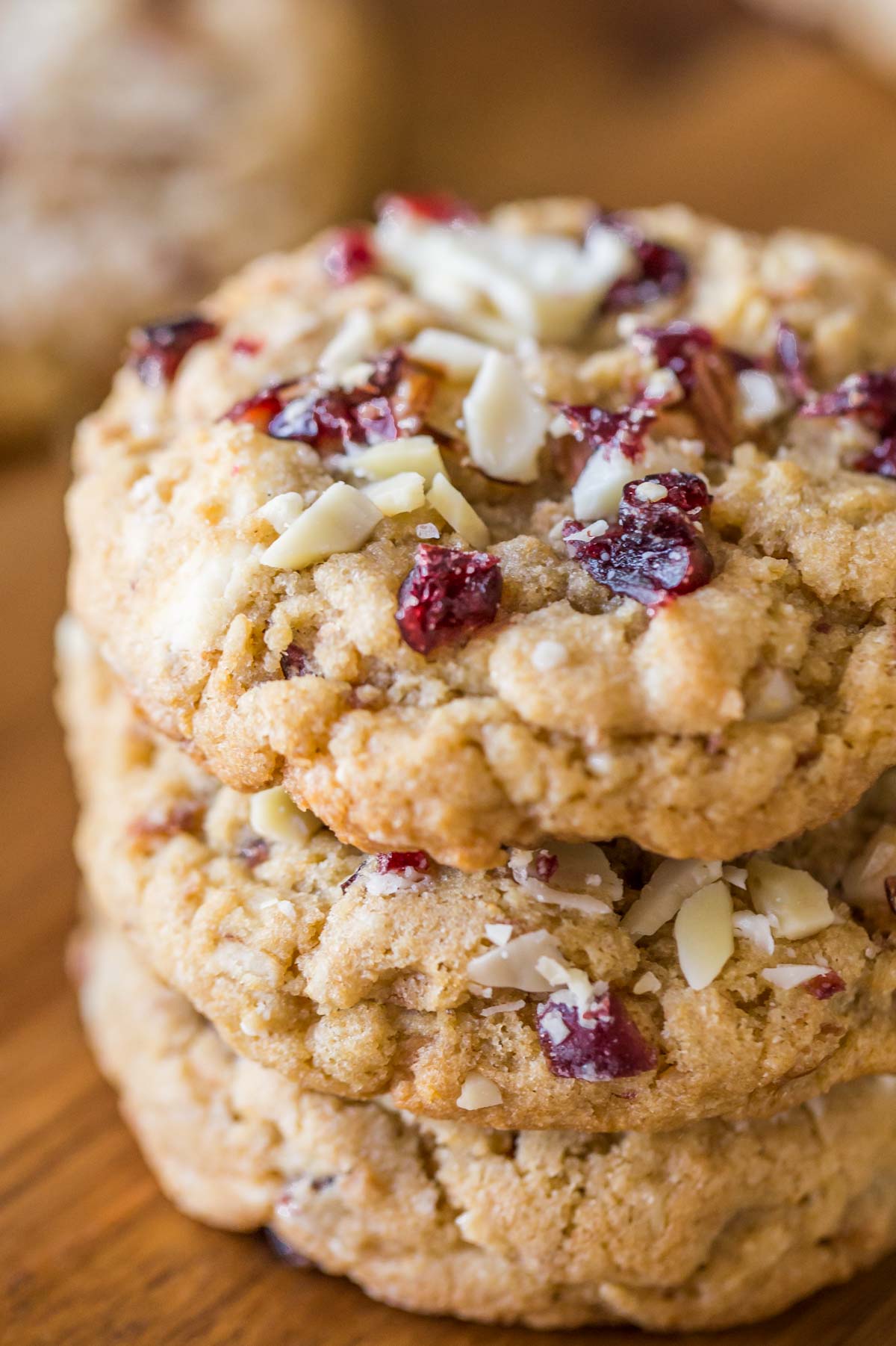 Cranberry Almond White Chocolate Chunk Cookies stacked in a pile of three. 