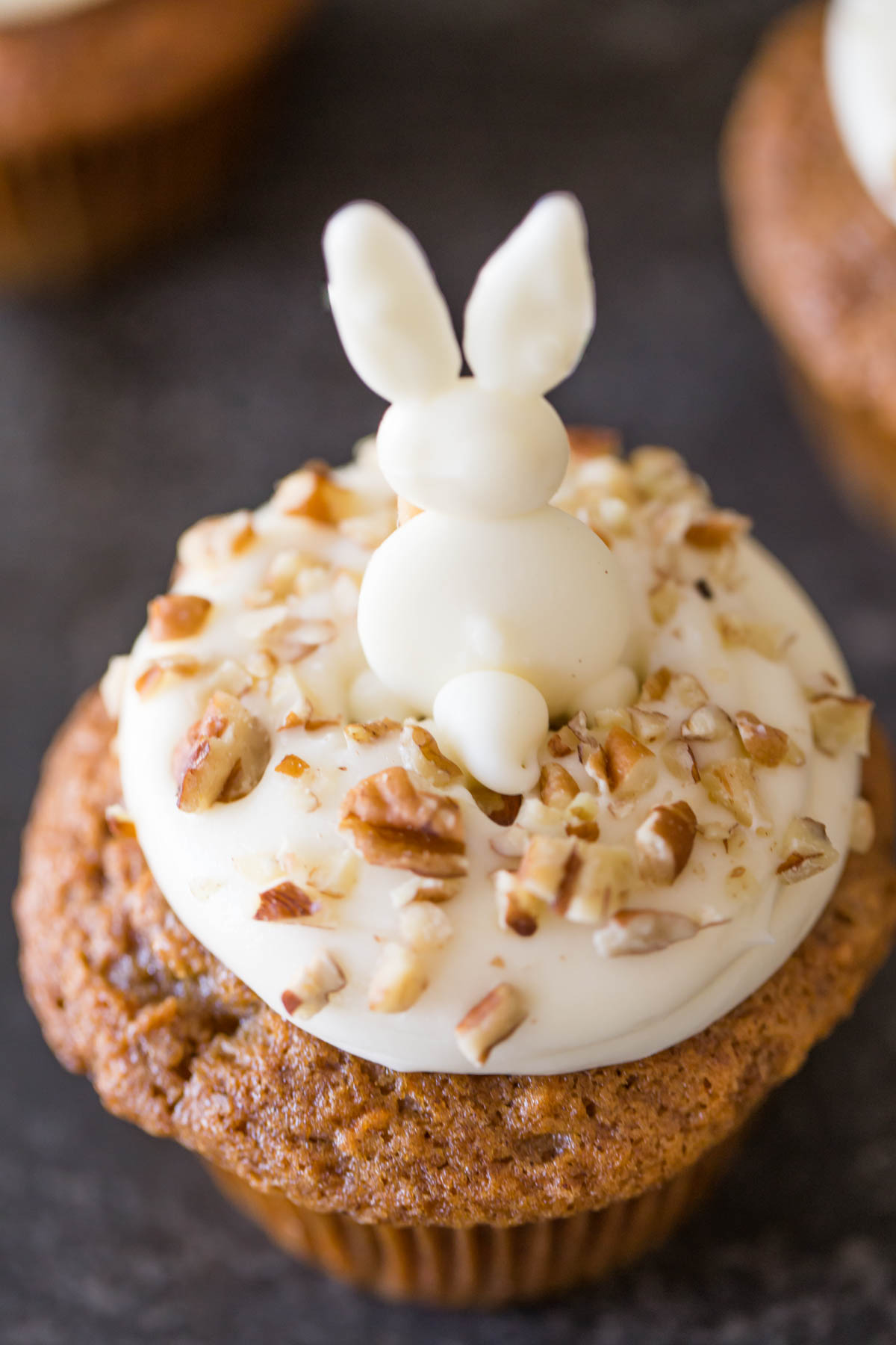 A Carrot Cake Cupcake with a white chocolate bunny on top.  