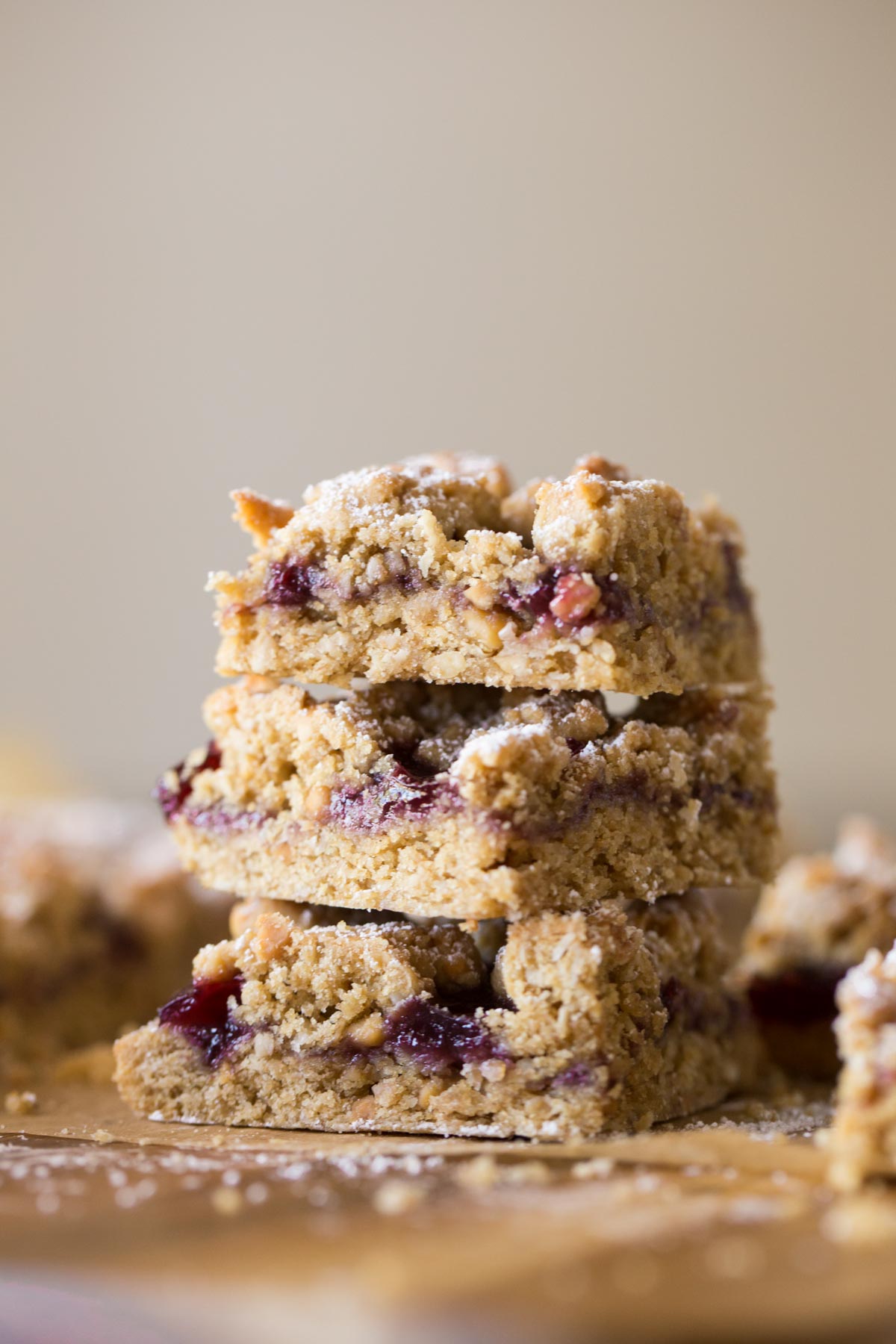 Three Peanut Butter and Jelly Oat Bars stacked on top of each other. 