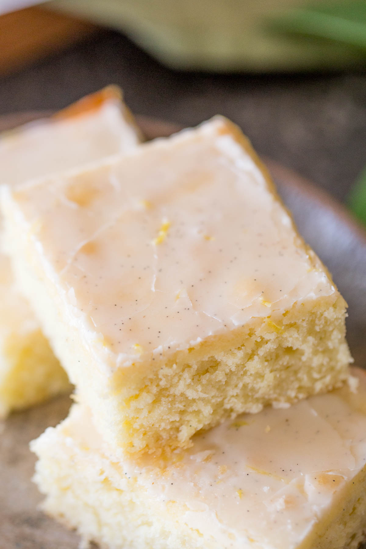 Three Vanilla Bean Lemon Bars on a plate. 