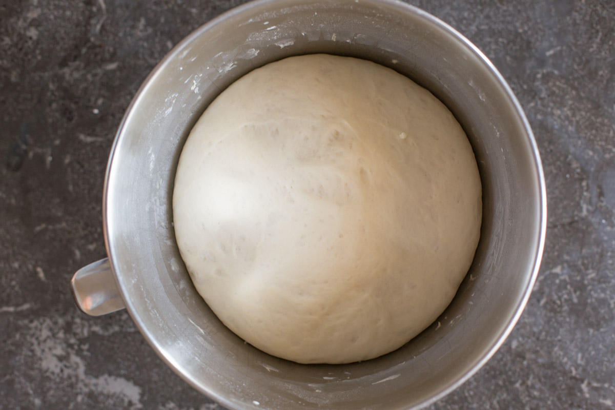 Fresh Buttery Garlic Breadsticks dough rising in mixer bowl.