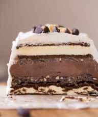 This Chocolate Peanut Butter Ice Cream Slice Cake is so clever, made with ice cream sandwiches, crunchy peanut butter ganache, and chocolate ice cream!