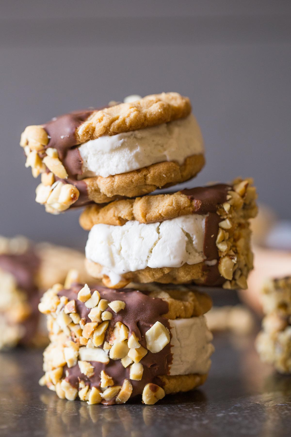 Three Peanut Butter Cookie Ice Cream Sandwiches stacked on top of each other. 