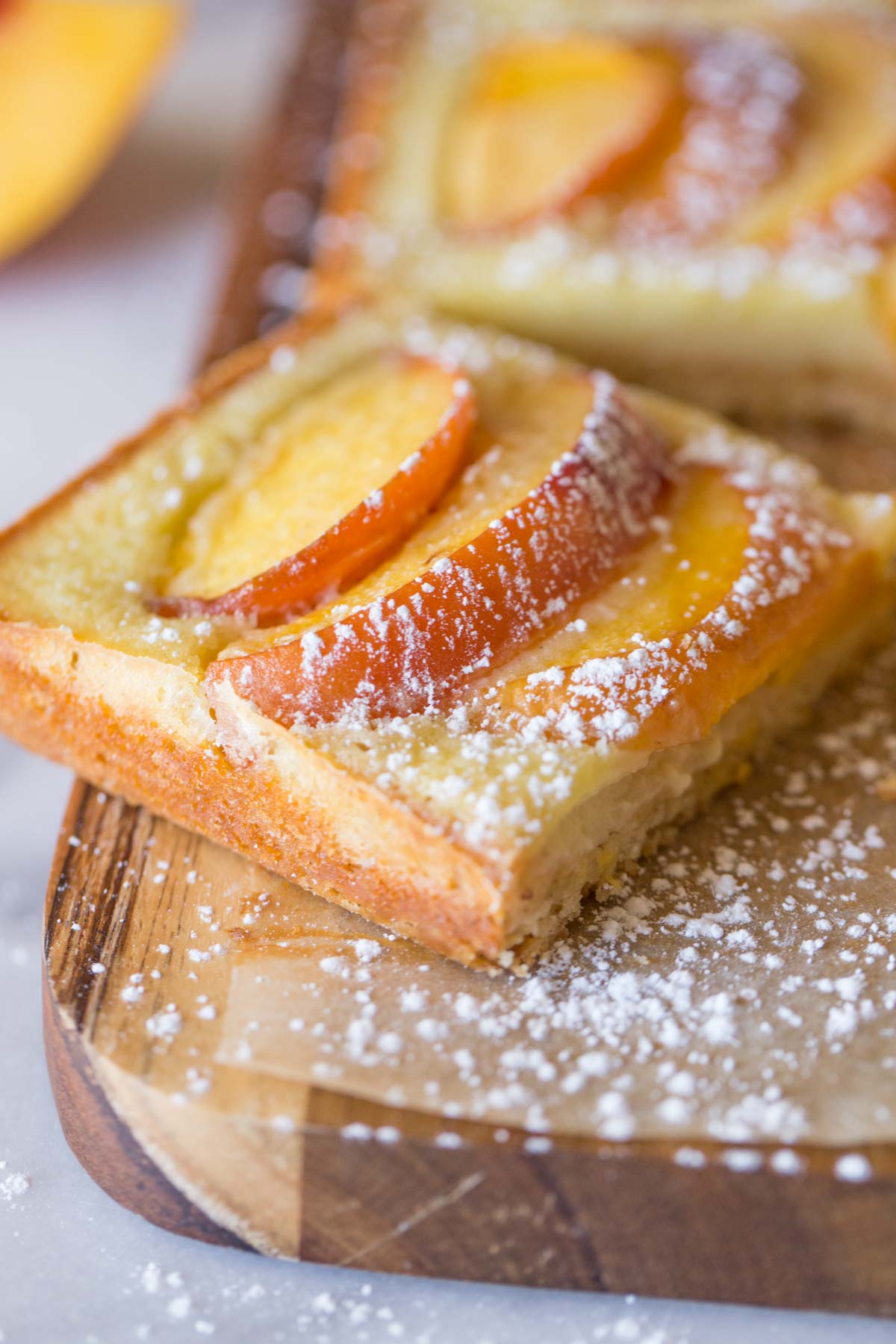 Peaches and Cream Shortbread Bars on a cutting board. 