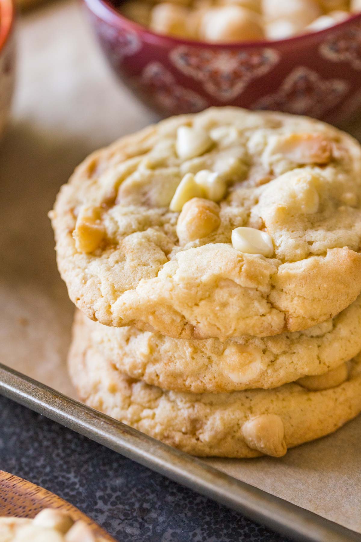 Three Buttery Toffee White Chocolate Chip Macadamia Nut Cookies stacked on top of each other.  